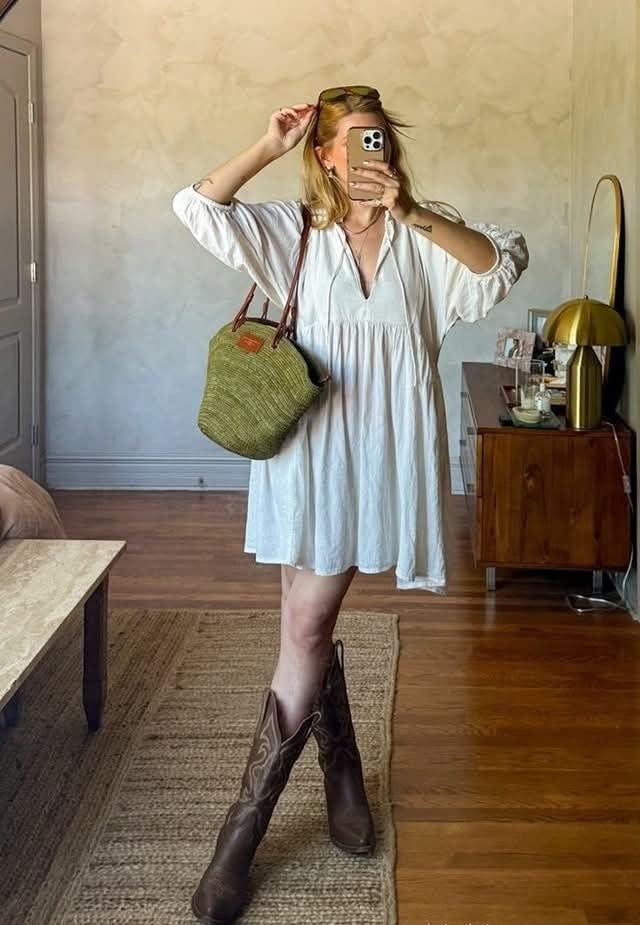 A woman wearing boho short white dress with boots